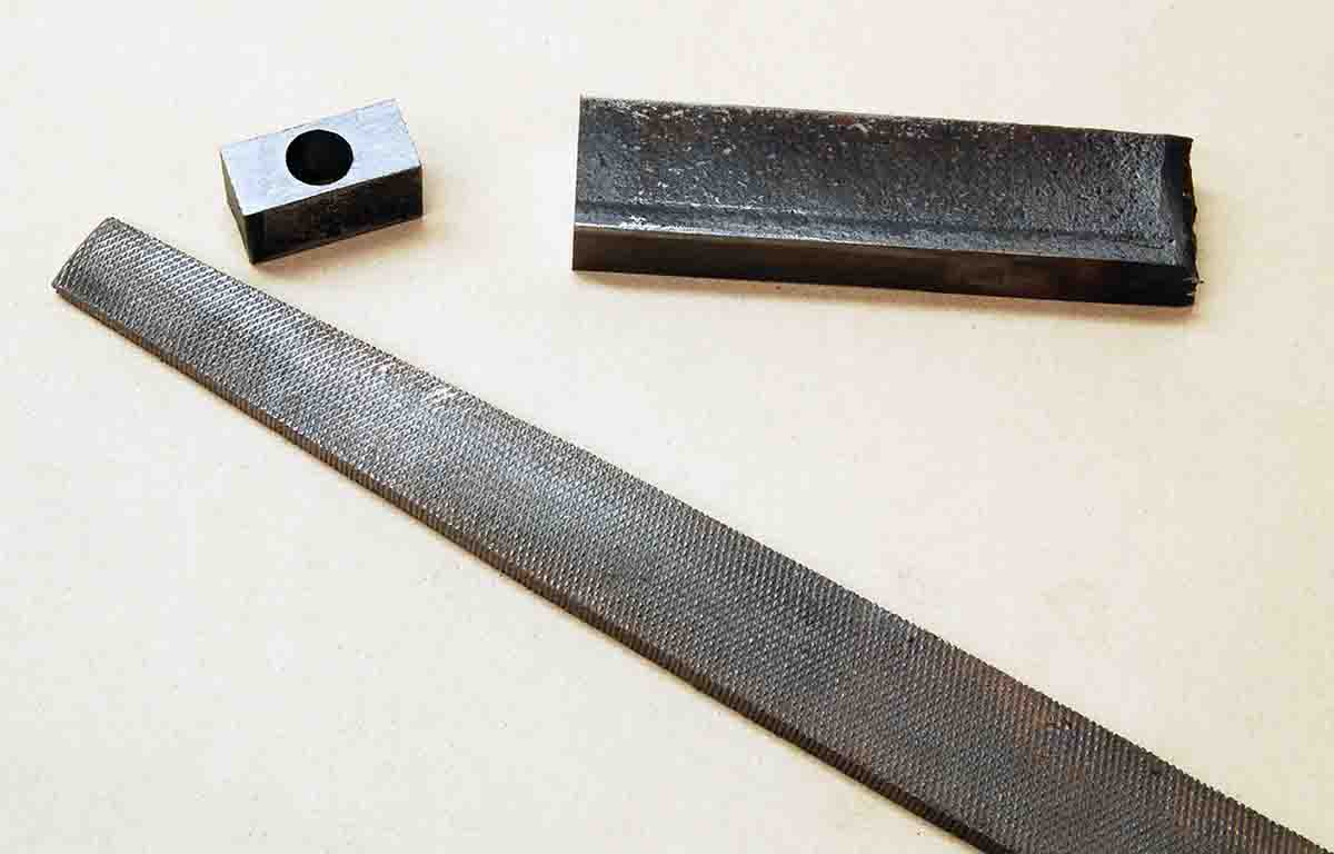 To tighten the forearm, a piece of half-inch mild steel plate is cut first and a hole drilled in its center to just slip-fit over the factory anchor.